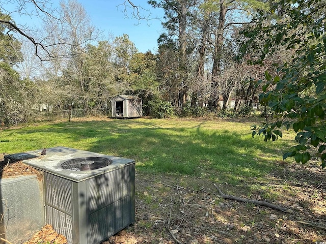 view of yard with a shed and central air condition unit