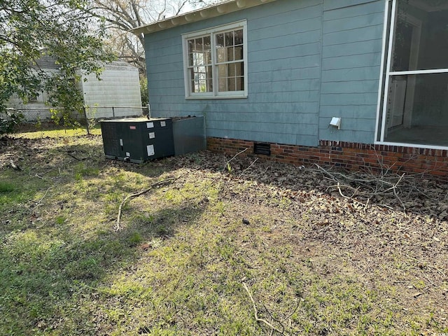 view of side of home with central AC unit