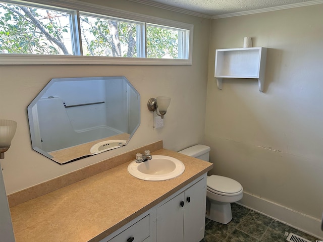 bathroom featuring vanity with extensive cabinet space, toilet, tile flooring, a textured ceiling, and ornamental molding