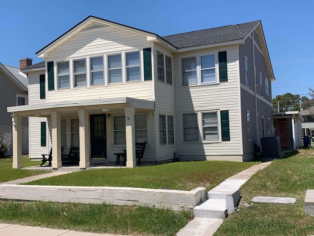 view of front of house featuring central AC and a front yard