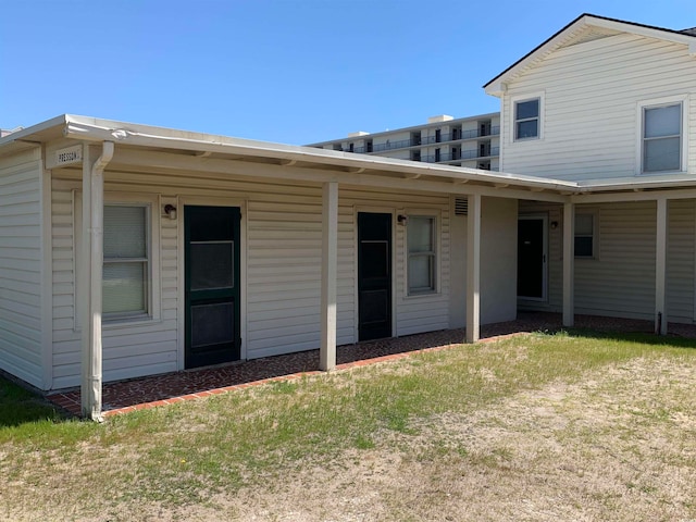 rear view of property with a yard