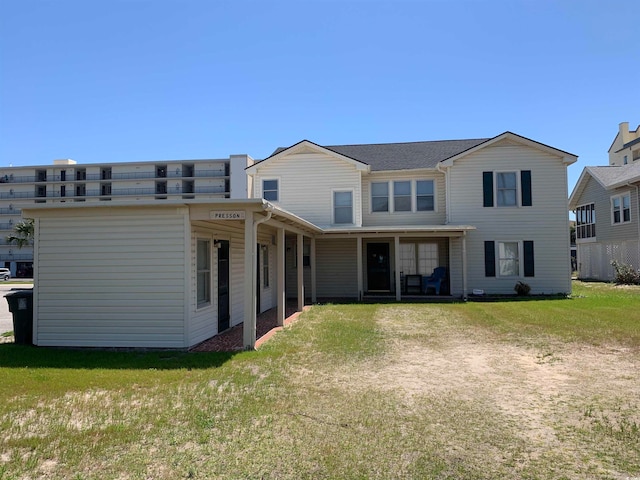 rear view of house with a yard