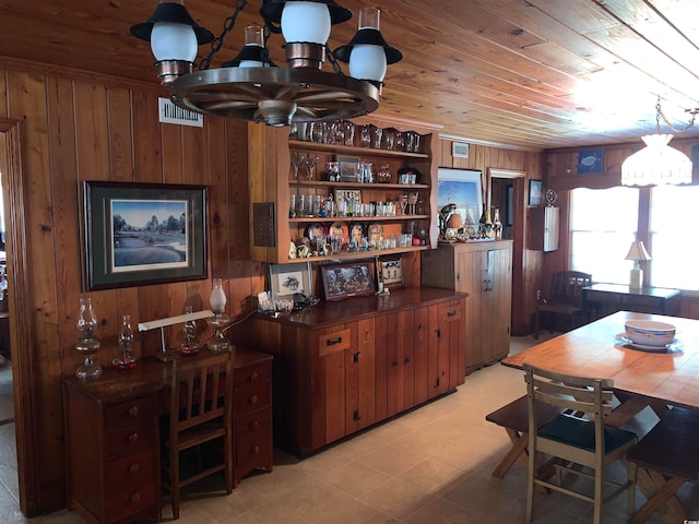 kitchen featuring wood ceiling, wood walls, and light tile floors