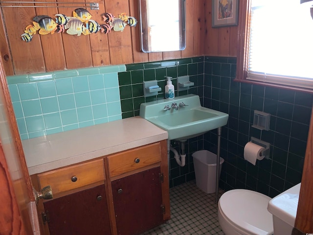 bathroom featuring tile walls, backsplash, tile floors, and toilet