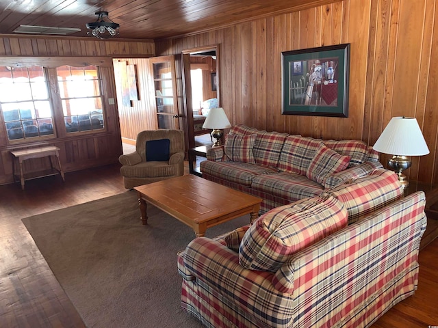 living room featuring wooden ceiling, wood walls, and dark wood-type flooring