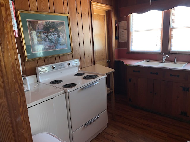 kitchen featuring wooden walls, dark wood-type flooring, sink, and white electric range