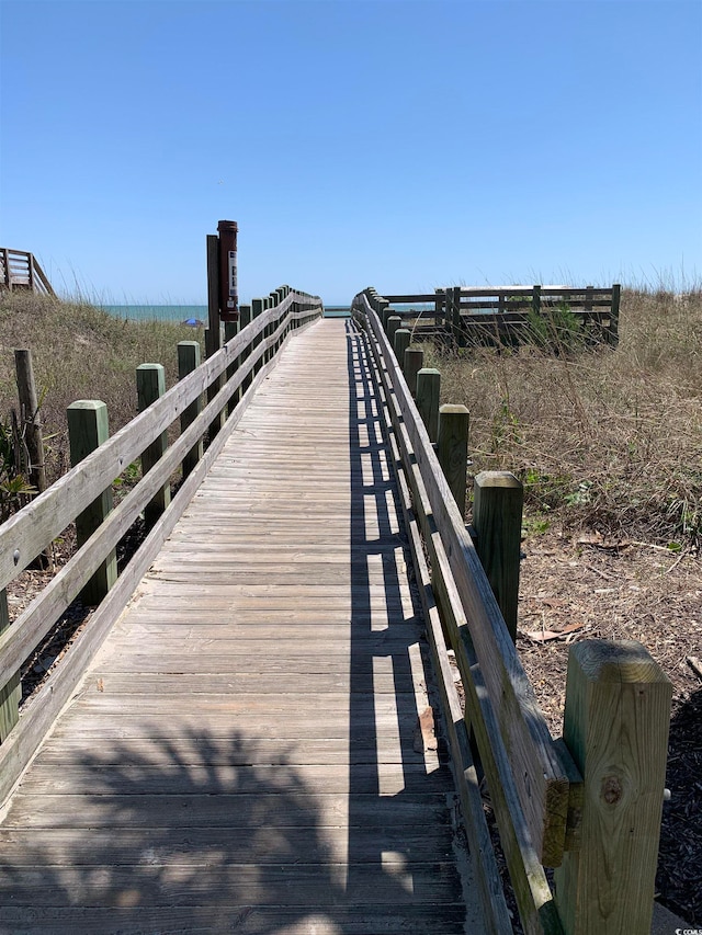 view of dock with a rural view