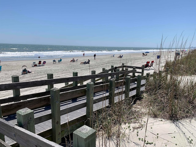 dock area featuring a beach view and a water view