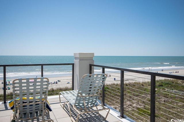 balcony with a beach view and a water view