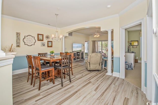 dining area with ceiling fan with notable chandelier, ornamental molding, light colored carpet, and decorative columns