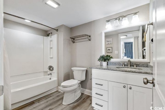 full bathroom with vanity with extensive cabinet space, toilet, bathtub / shower combination, and hardwood / wood-style flooring