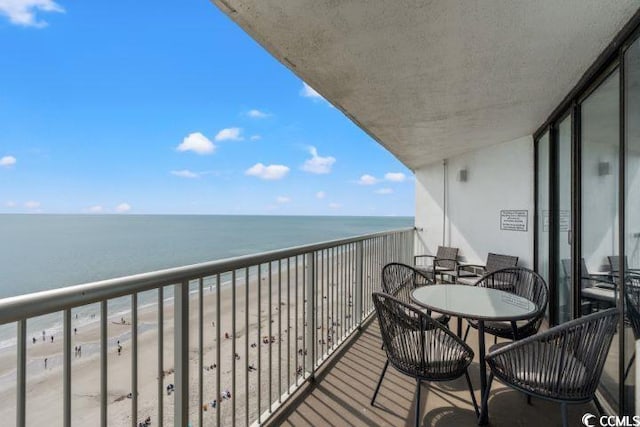 balcony with a view of the beach and a water view