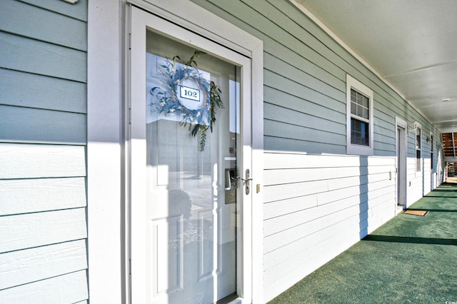 view of exterior entry with covered porch