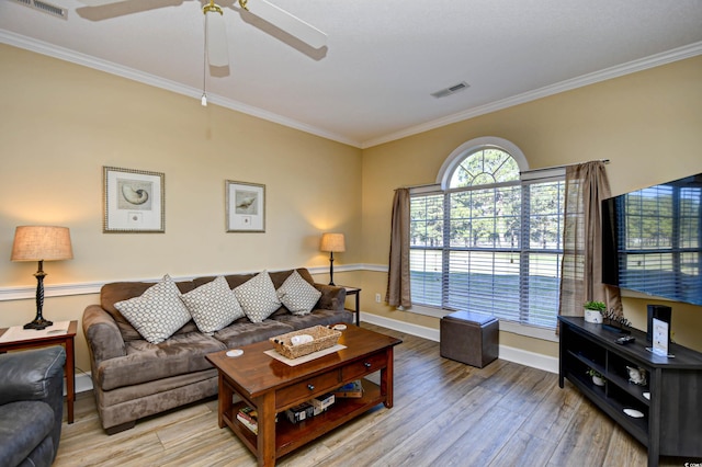 living room with light hardwood / wood-style floors, ceiling fan, and crown molding