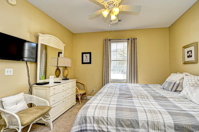 bedroom featuring light colored carpet and ceiling fan