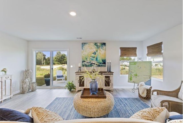 living area with wood finished floors and baseboards