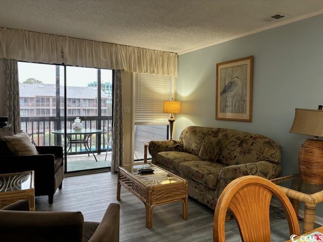 212 2nd Ave N Unit 362, North Myrtle Beach, SC 29582 - living room featuring crown molding, a textured ceiling, wood finished floors, and visible vents