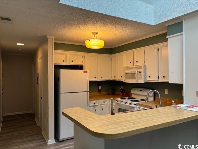 kitchen featuring a textured ceiling, white appliances, white cabinetry, dark hardwood / wood-style flooring, and kitchen peninsula