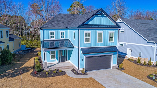 view of front facade with a porch, a standing seam roof, roof with shingles, and driveway