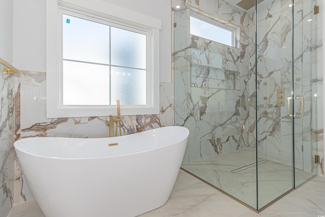 full bath with marble finish floor, a marble finish shower, and a soaking tub