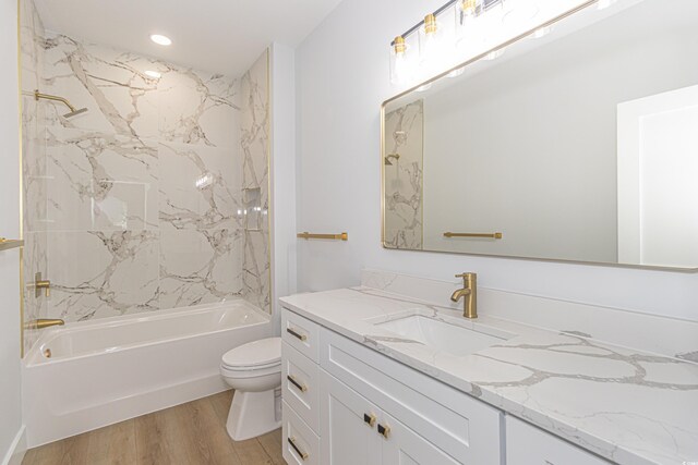 bathroom featuring shower / bathtub combination, recessed lighting, toilet, vanity, and wood finished floors