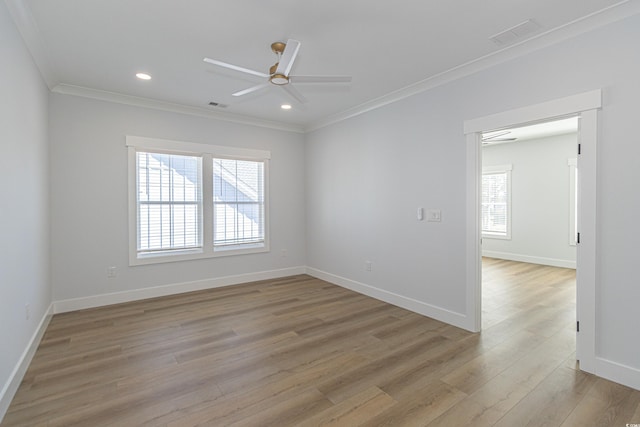 unfurnished room featuring baseboards, light wood-style floors, a wealth of natural light, and crown molding