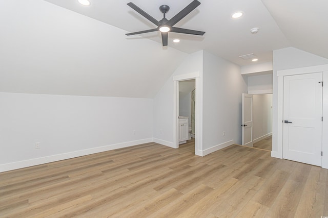 additional living space with lofted ceiling, light wood-style flooring, baseboards, and recessed lighting