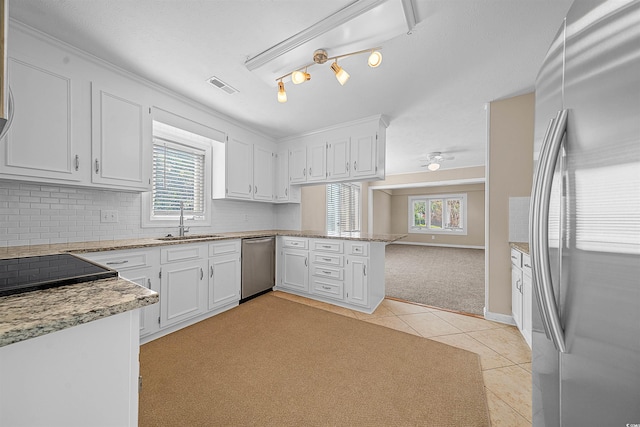 kitchen with white cabinets, sink, a healthy amount of sunlight, and stainless steel appliances