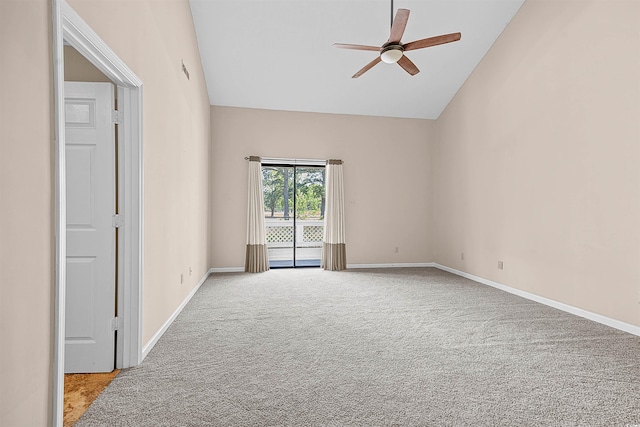 carpeted spare room with ceiling fan and lofted ceiling