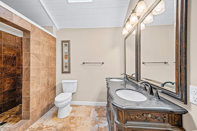 bathroom with tile flooring, beamed ceiling, large vanity, toilet, and wooden ceiling