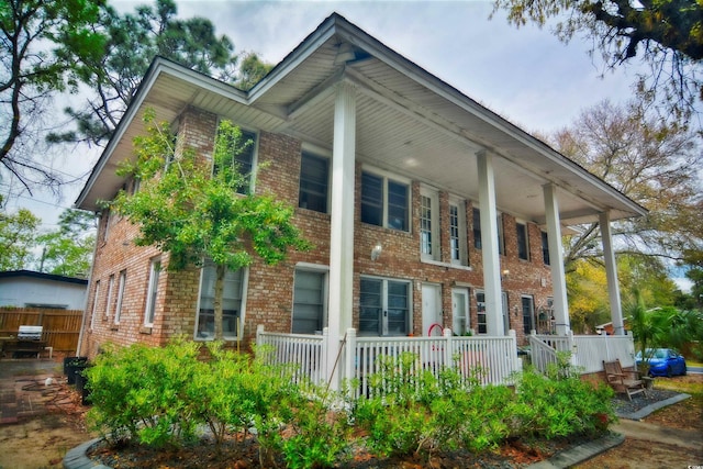 view of side of home with covered porch