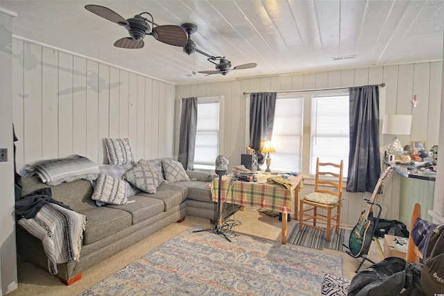 carpeted living room with ceiling fan