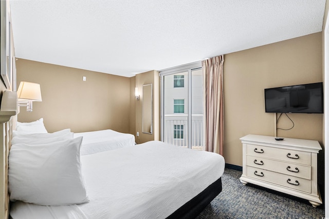 carpeted bedroom with a textured ceiling