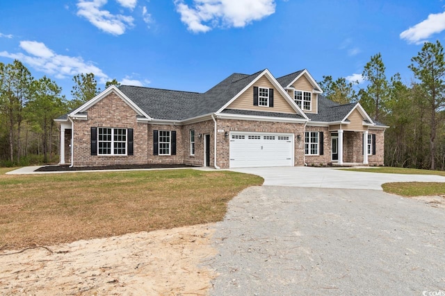 craftsman house featuring a garage and a front lawn