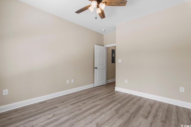 spare room with ceiling fan and light wood-type flooring