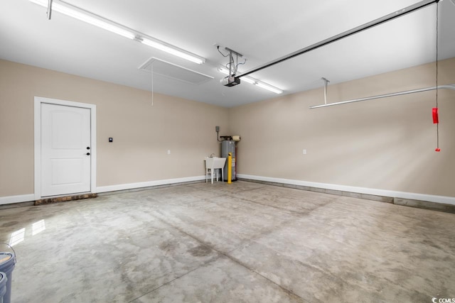 garage featuring water heater and a garage door opener