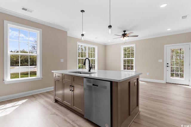 kitchen featuring dishwasher, a kitchen island with sink, sink, pendant lighting, and light wood-type flooring