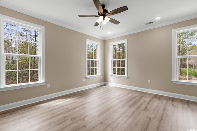 spare room featuring light hardwood / wood-style flooring, ceiling fan, and ornamental molding