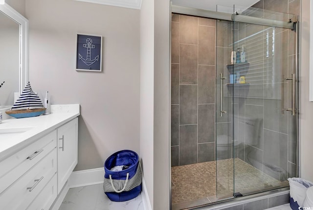 bathroom with an enclosed shower, vanity, and ornamental molding