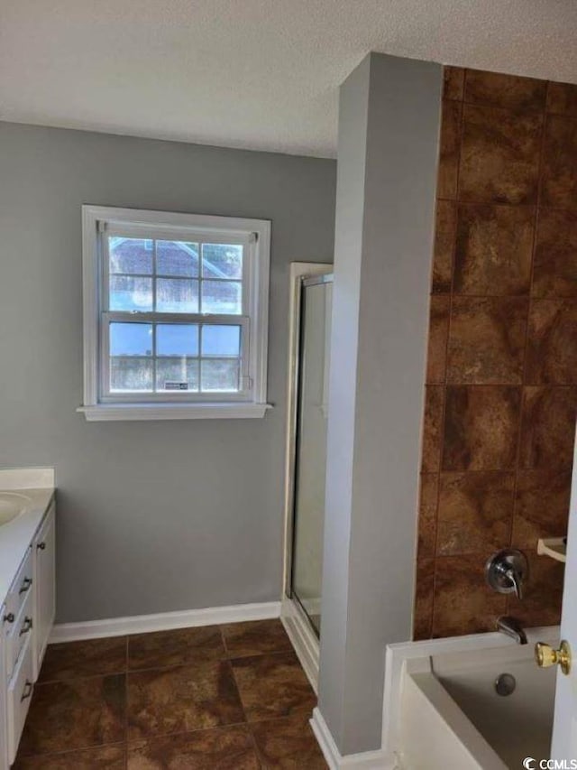 bathroom featuring vanity, tile patterned flooring, and a textured ceiling