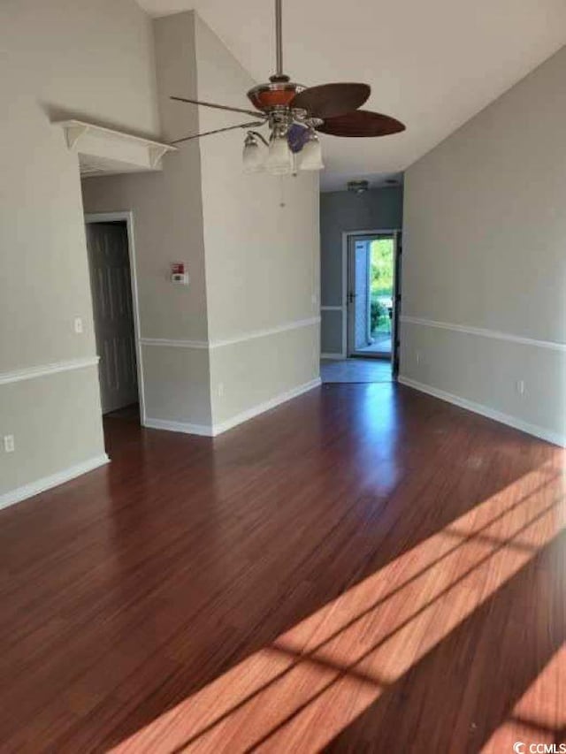 spare room with vaulted ceiling, hardwood / wood-style floors, and ceiling fan