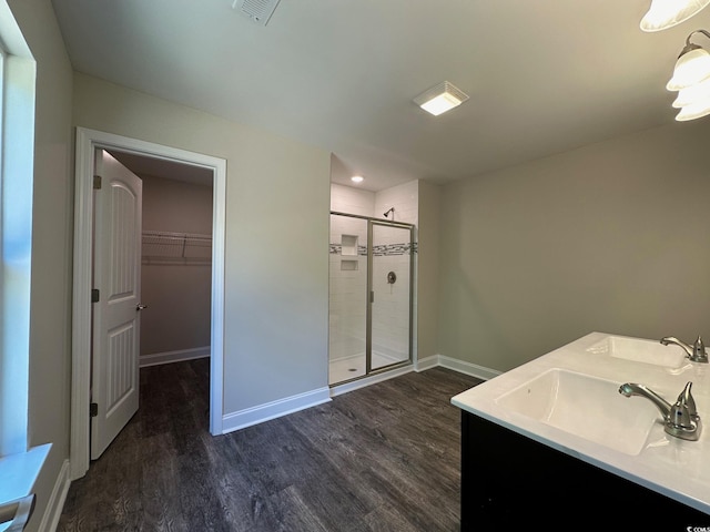 bathroom featuring hardwood / wood-style floors, vanity, and an enclosed shower