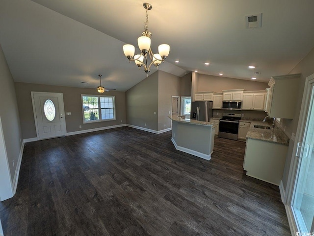 kitchen with visible vents, dark wood-type flooring, a sink, a center island, and appliances with stainless steel finishes