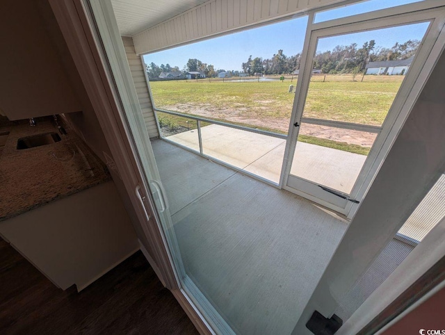 doorway to outside with a sink