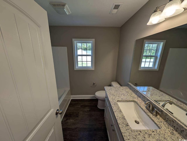 bathroom with visible vents, baseboards, toilet, and vanity