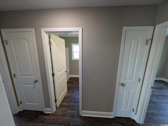 hall featuring dark wood finished floors and baseboards