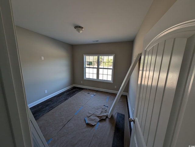 spare room featuring visible vents and baseboards