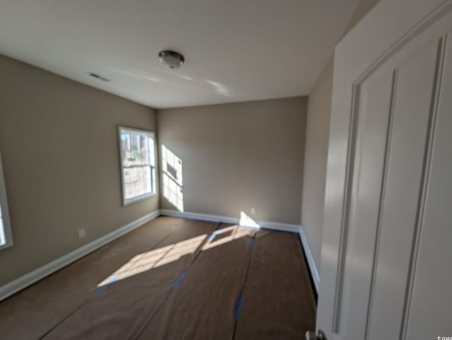 unfurnished bedroom featuring baseboards and visible vents