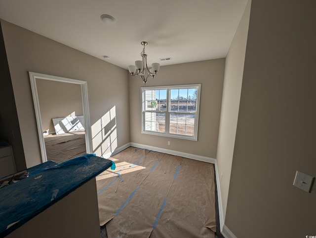 dining space featuring a notable chandelier, baseboards, and visible vents