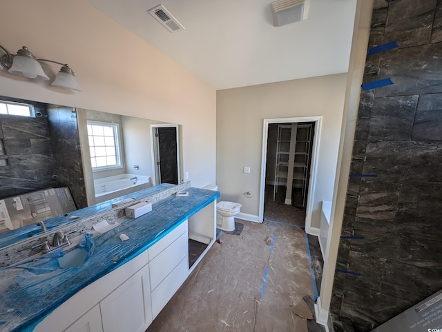 full bathroom featuring visible vents, baseboards, a garden tub, a tile shower, and vanity